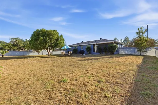 a view of swimming pool with outdoor seating and yard in back