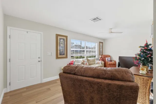 a living room with furniture and a potted plant
