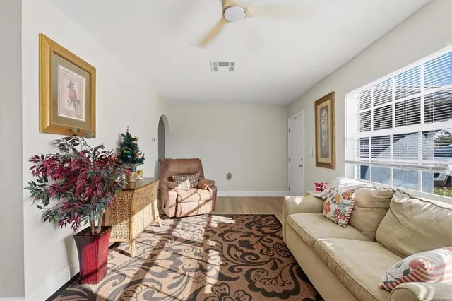 a living room with furniture and flowers