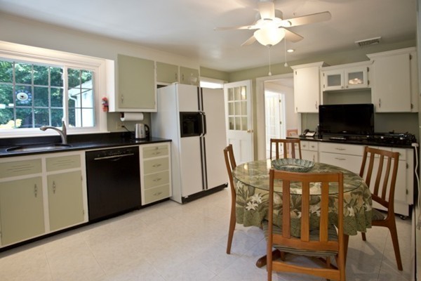 18 Chatham Way Lynnfield, MA 01940 - Photo 10 of 28 a kitchen with a table chairs sink and cabinets