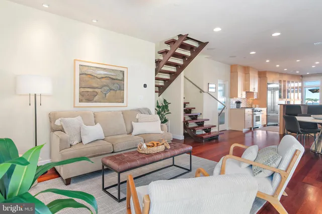 a kitchen with kitchen island granite countertop a table chairs sink and cabinets