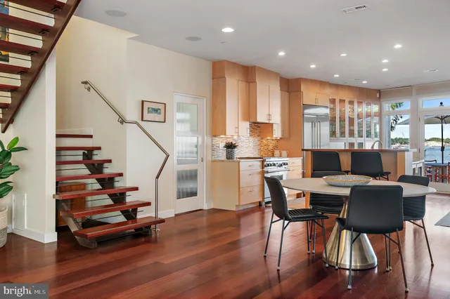 a kitchen with a stove a sink a dining table and chairs