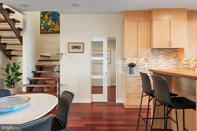 a bedroom with a large bed and a flat tv screen on dresser