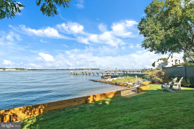 a front view of a house with a yard table and chairs
