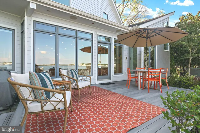 a living room with furniture a flat screen tv and a potted plant