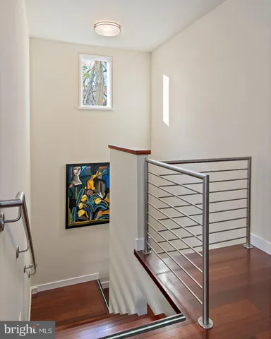 a view of a chair and tables under an umbrella