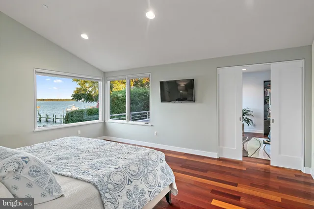 a view of a big house with a big yard plants and large trees