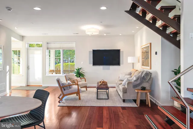 a living room with furniture a fireplace and a floor to ceiling window