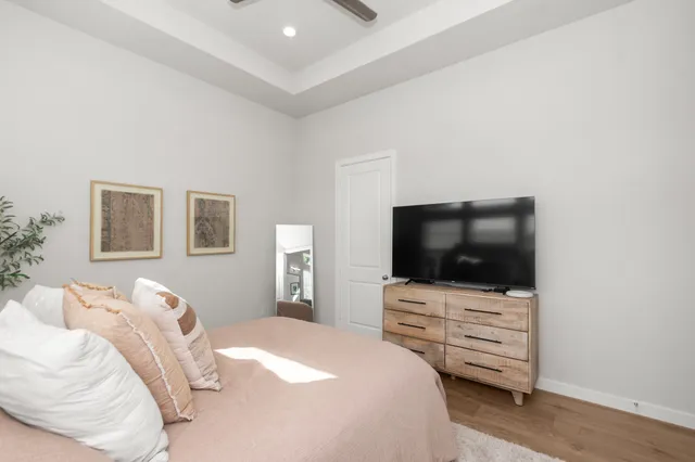 a bedroom with a bed and a potted plant