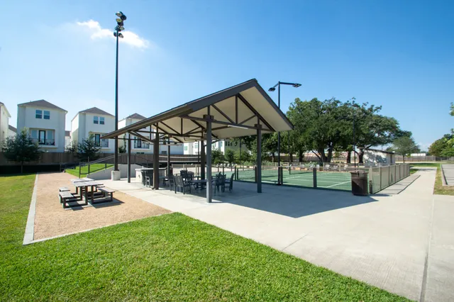 a view of backyard with wooden fence