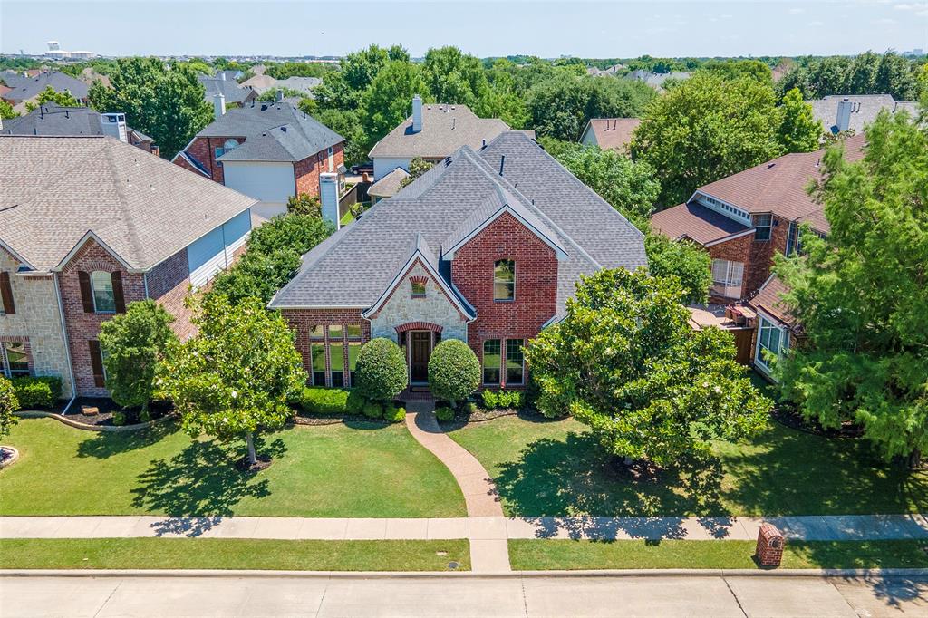 1217 Windmere Way Allen, TX 75013 - Photo 1 of 38 Framed by mature magnolia trees and manicured landscaping, this stately brick-and-stone elevation creates a warm first impression from the moment you arrive.