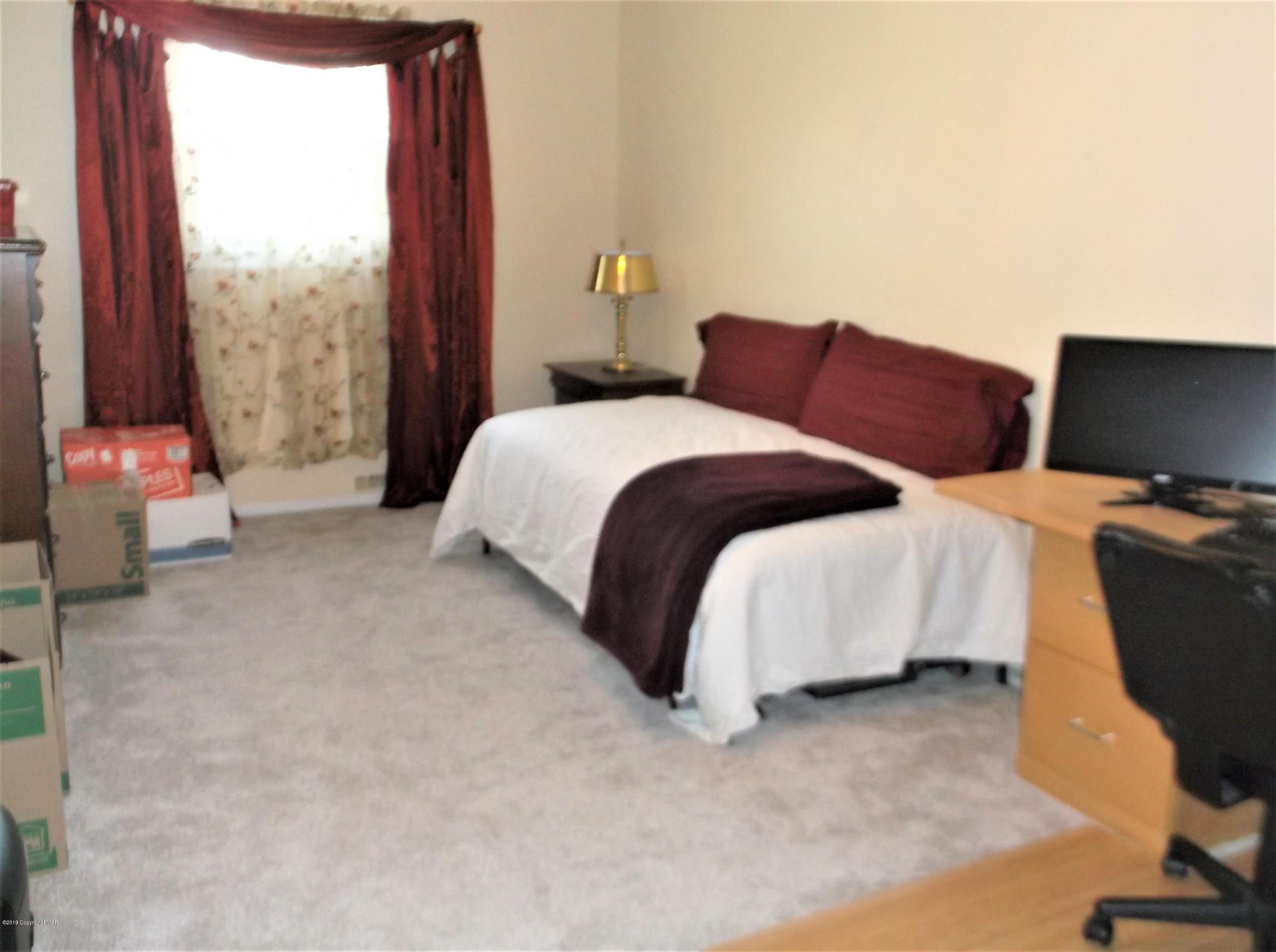 112 Sage Road Long Pond, PA 18334 - Photo 21 of 39 a bedroom with a bed and large window