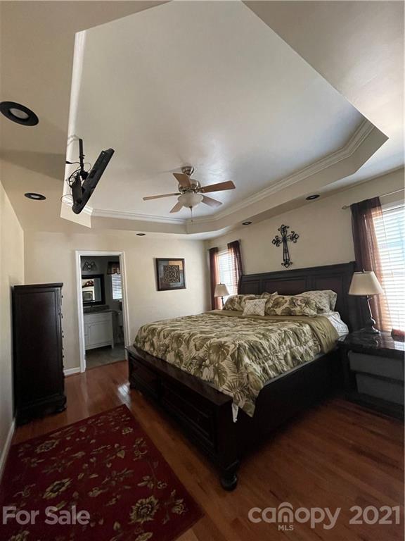 770 Padgett Road Union Mills, NC 28167 - Photo 11 of 48 a bedroom with a large bed and a chandelier
