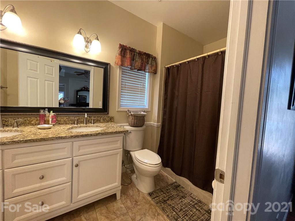 770 Padgett Road Union Mills, NC 28167 - Photo 12 of 48 a bathroom with a granite countertop sink toilet and shower