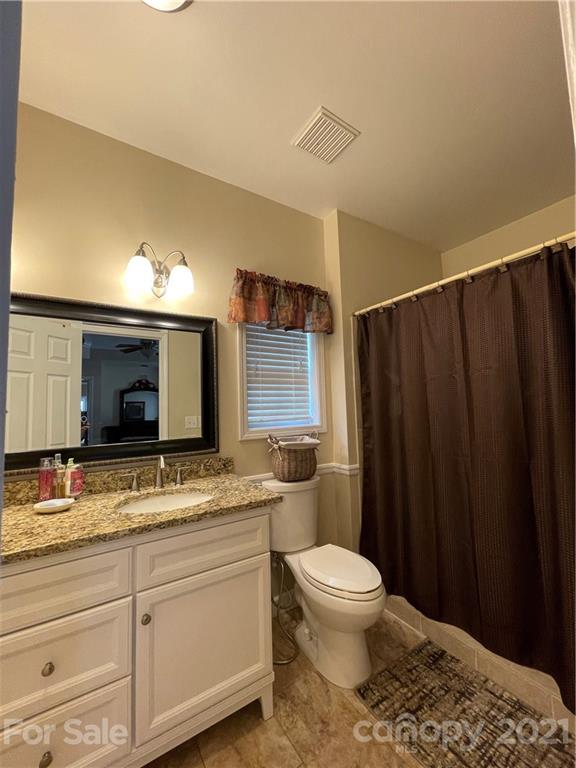 770 Padgett Road Union Mills, NC 28167 - Photo 13 of 48 a bathroom with a granite countertop sink toilet and shower