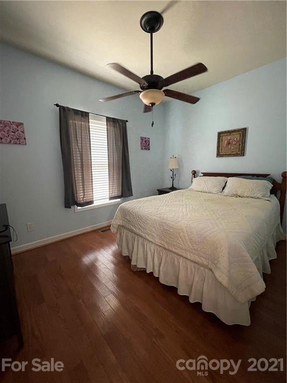 770 Padgett Road Union Mills, NC 28167 - Photo 32 of 48 a bedroom with a large bed chandelier and a window