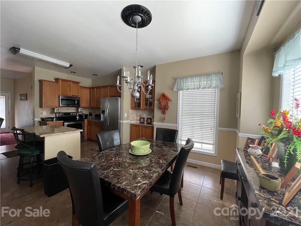 770 Padgett Road Union Mills, NC 28167 - Photo 5 of 48 a kitchen with a table chairs and center island