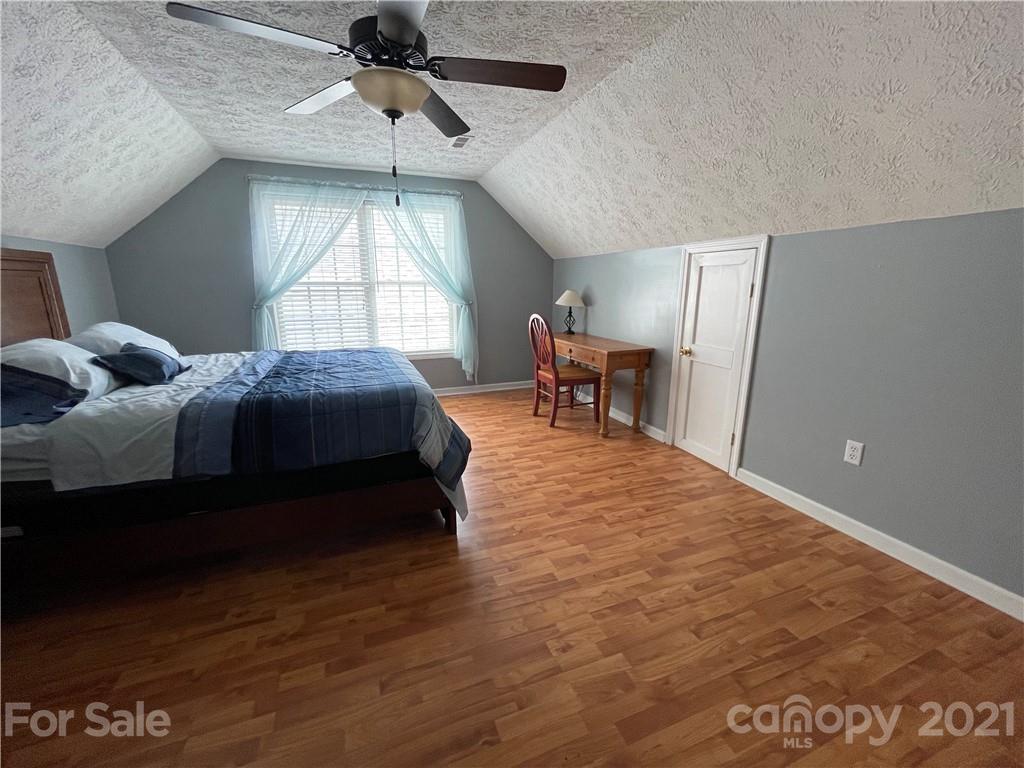 770 Padgett Road Union Mills, NC 28167 - Photo 41 of 48 a bedroom with a bed and a chandelier