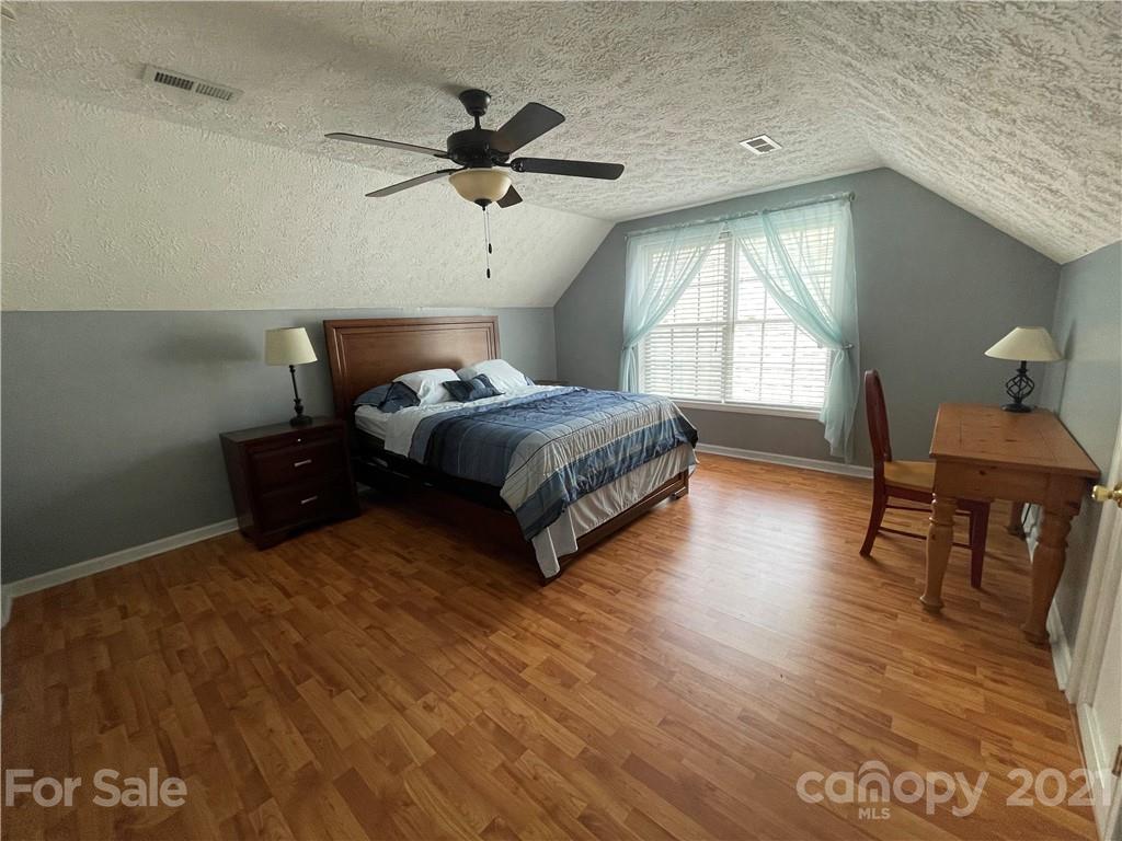 770 Padgett Road Union Mills, NC 28167 - Photo 42 of 48 a spacious bedroom with a bed and a table in it