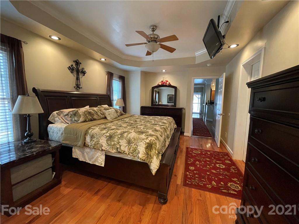 770 Padgett Road Union Mills, NC 28167 - Photo 10 of 48 a bedroom with a bed and a chandelier