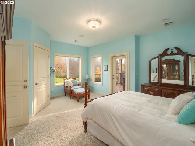 a bedroom with a bed and a refrigerator