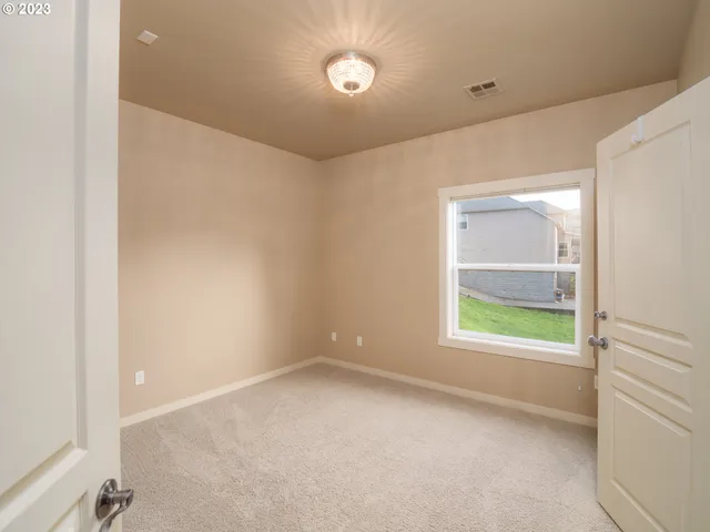 an empty room with a bathroom and a sink
