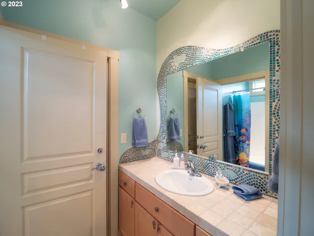 a bathroom with a shower and a sink