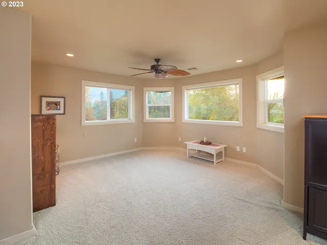 a view of a livingroom with a furniture and a ceiling fan