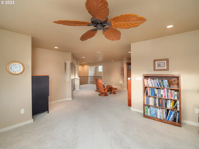 a view of a livingroom with furniture and a refrigerator