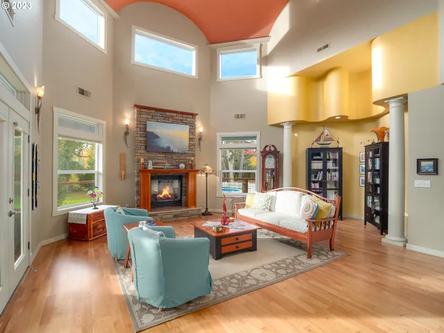 a living room with fireplace furniture and a wooden floor