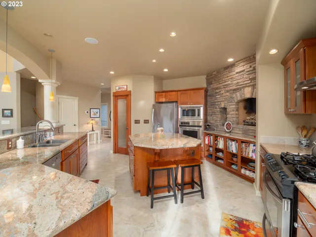 a kitchen with a sink and a stove with wooden floor