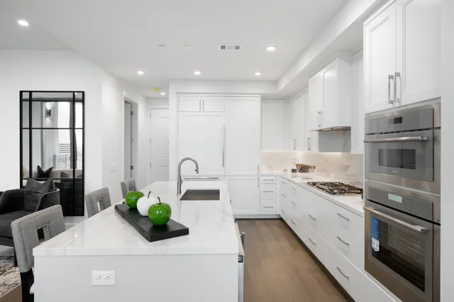 a large bed sitting in a bedroom next to a window