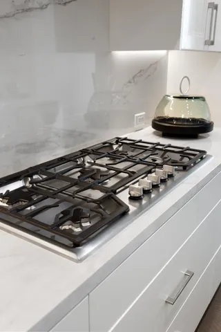a bathroom with a toilet sink vanity and mirror
