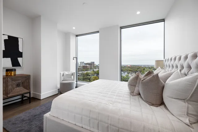 a living room with furniture a fireplace and a chandelier