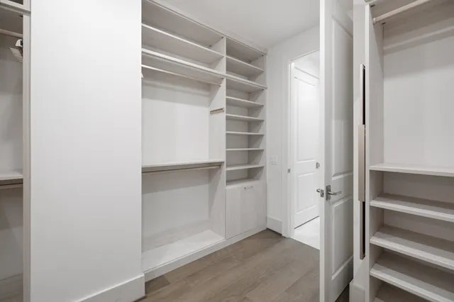 a view of a dining room with furniture and a kitchen view