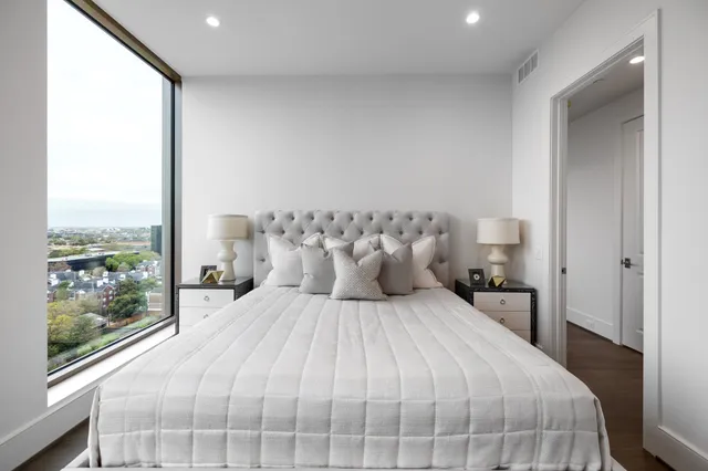 a living room with lots of furniture and a large window