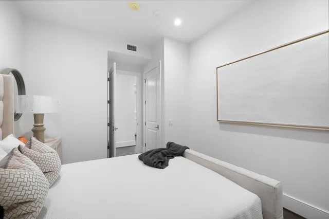 a living room with furniture a flat screen tv and kitchen view