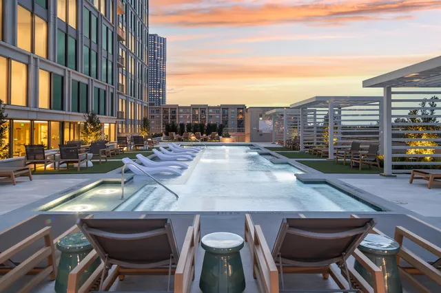 a living room with furniture kitchen view and a table