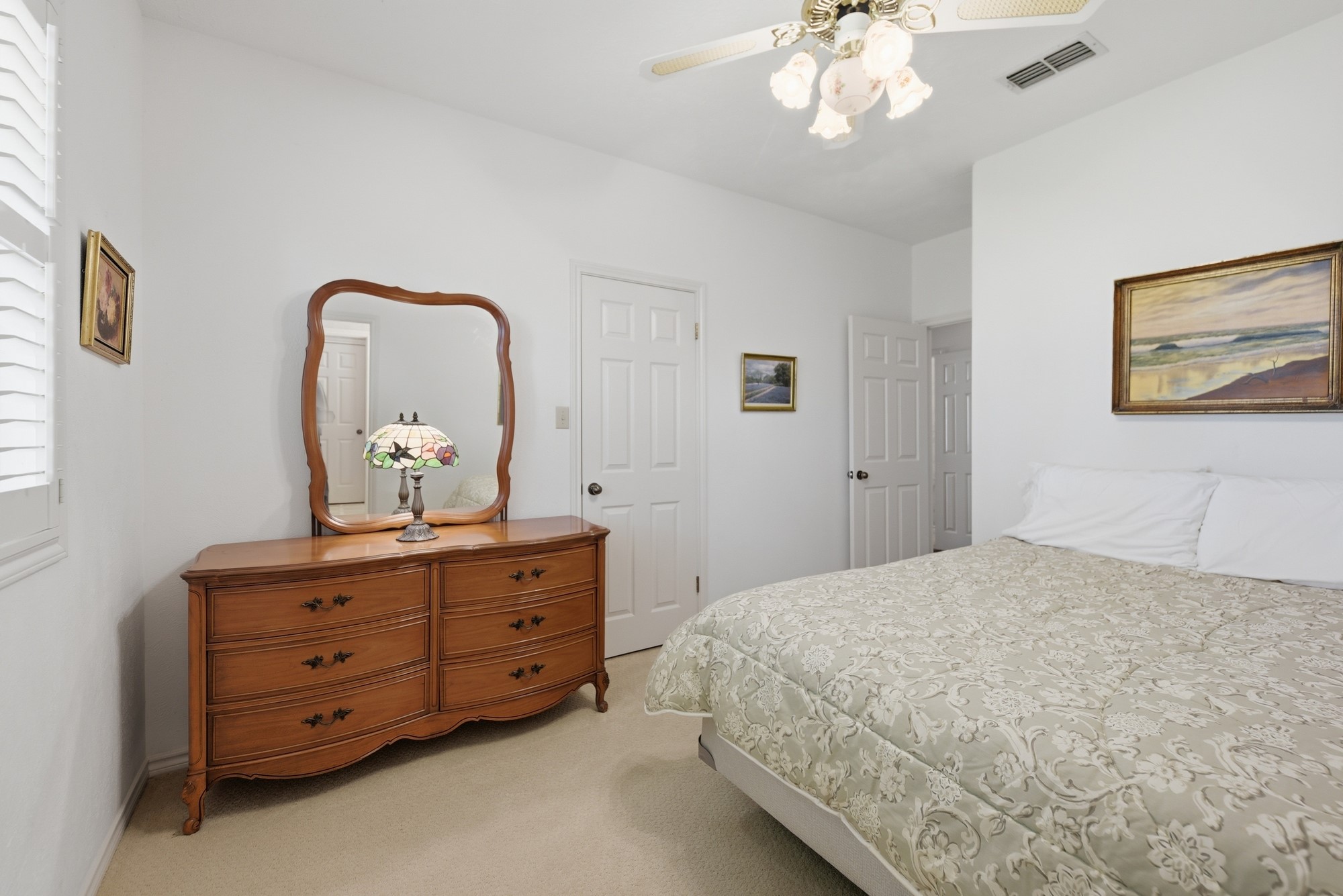 1552 Holub Road Schulenburg, TX 78956 - Photo 31 of 35 A comfortable bedroom features carpet flooring and a practical ceiling fan for year-round comfort.