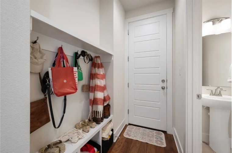 344 Pisa Lane Georgetown, TX 78628 - Photo 19 of 39 A functional mudroom entry features built-in storage cubbies, coat hooks, and durable hardwood flooring.