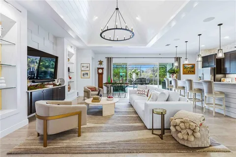 a kitchen with stainless steel appliances kitchen island granite countertop a sink refrigerator and microwave