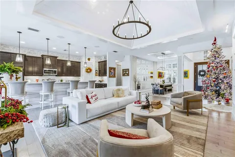 a kitchen with stainless steel appliances granite countertop a sink stove and wooden floor