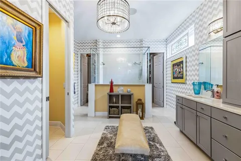 a bedroom with a bed and a chandelier