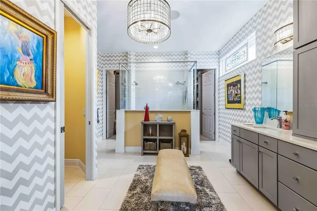 a bedroom with a bed and a chandelier