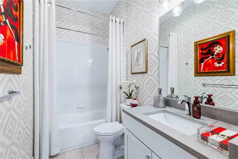 a living room with furniture a flat screen tv and a window