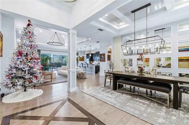 a living room with furniture a flat screen tv and a large window