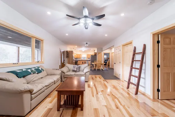 a living room with furniture and a wooden floor