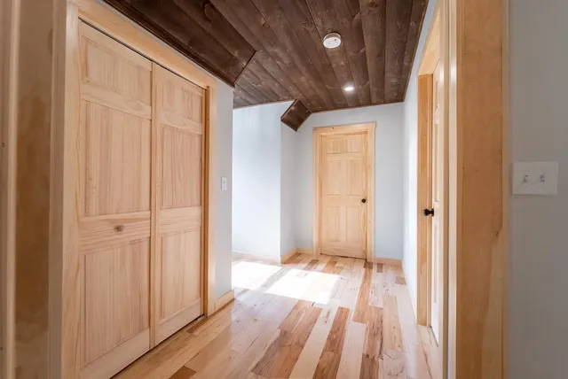 a view of a room with wooden floor