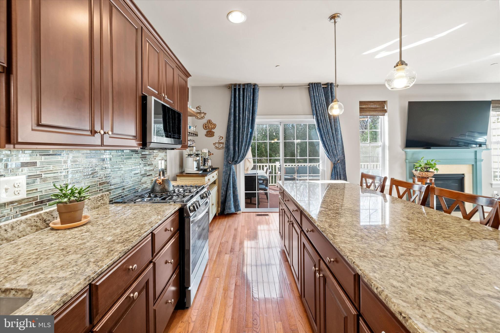 264 Deepdale Drive, Unit 31 Kennett Square, PA 19348 - Photo 11 of 34 a kitchen with stainless steel appliances granite countertop a sink a stove and a wooden floors