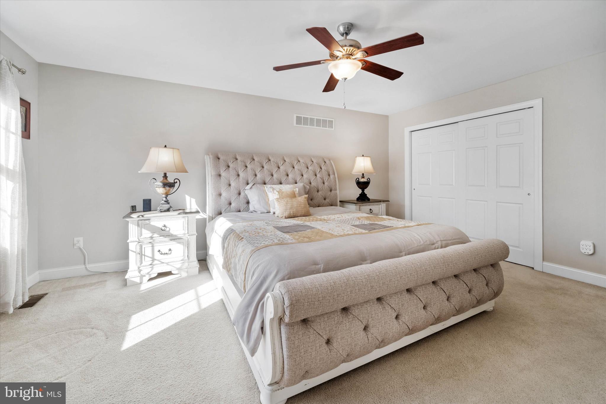264 Deepdale Drive, Unit 31 Kennett Square, PA 19348 - Photo 16 of 34 a bedroom with a bed and a chandelier